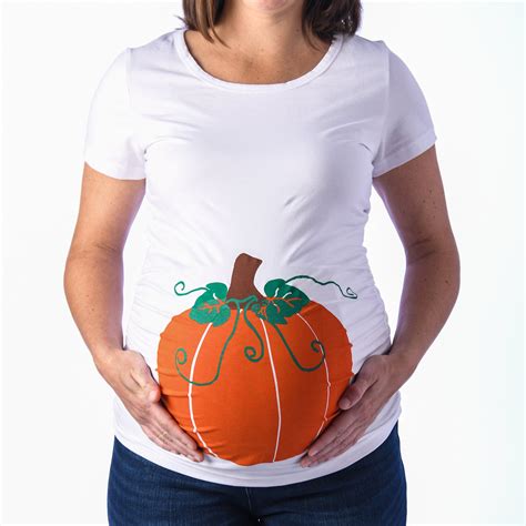 Cut out the hole of your belly and adorn the area with tomato shapes, cut out of red and green felt. . Pumpkin pregnancy shirt